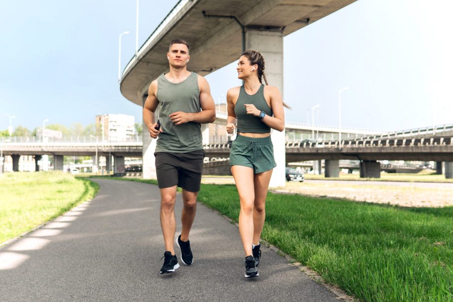 Sportive couple during jogging workout on city street healthy couple